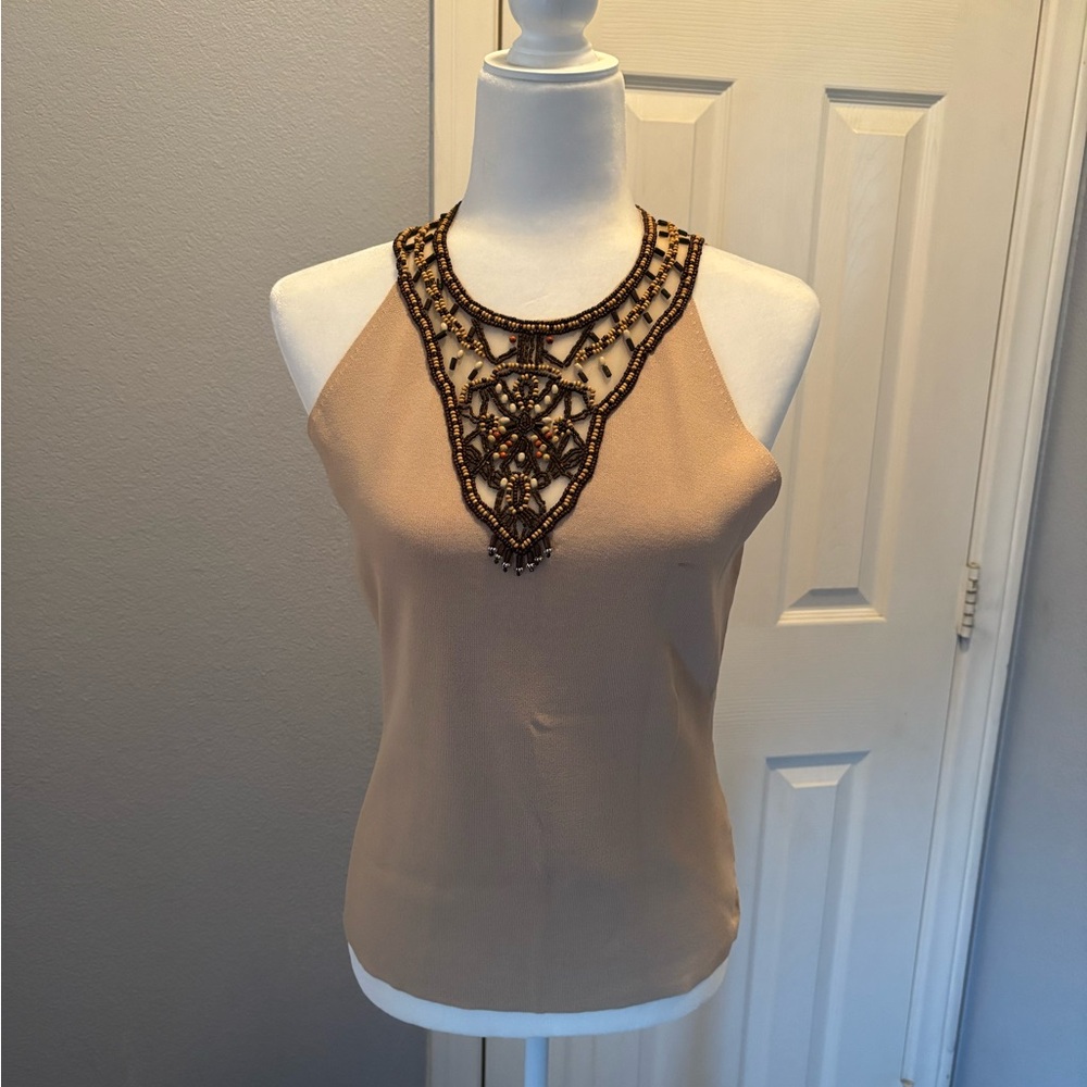 Tan top with a beaded neckline.